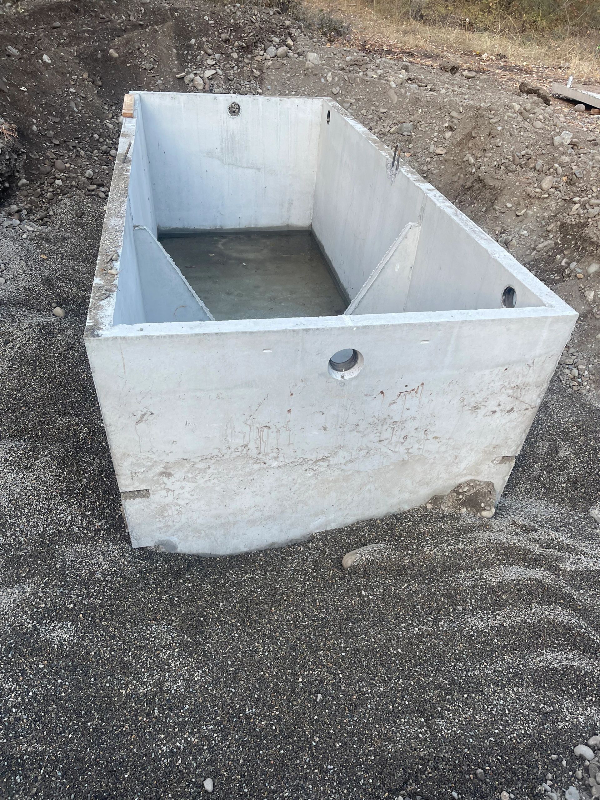 Precast concrete septic pump station tank set in the ground for a campground