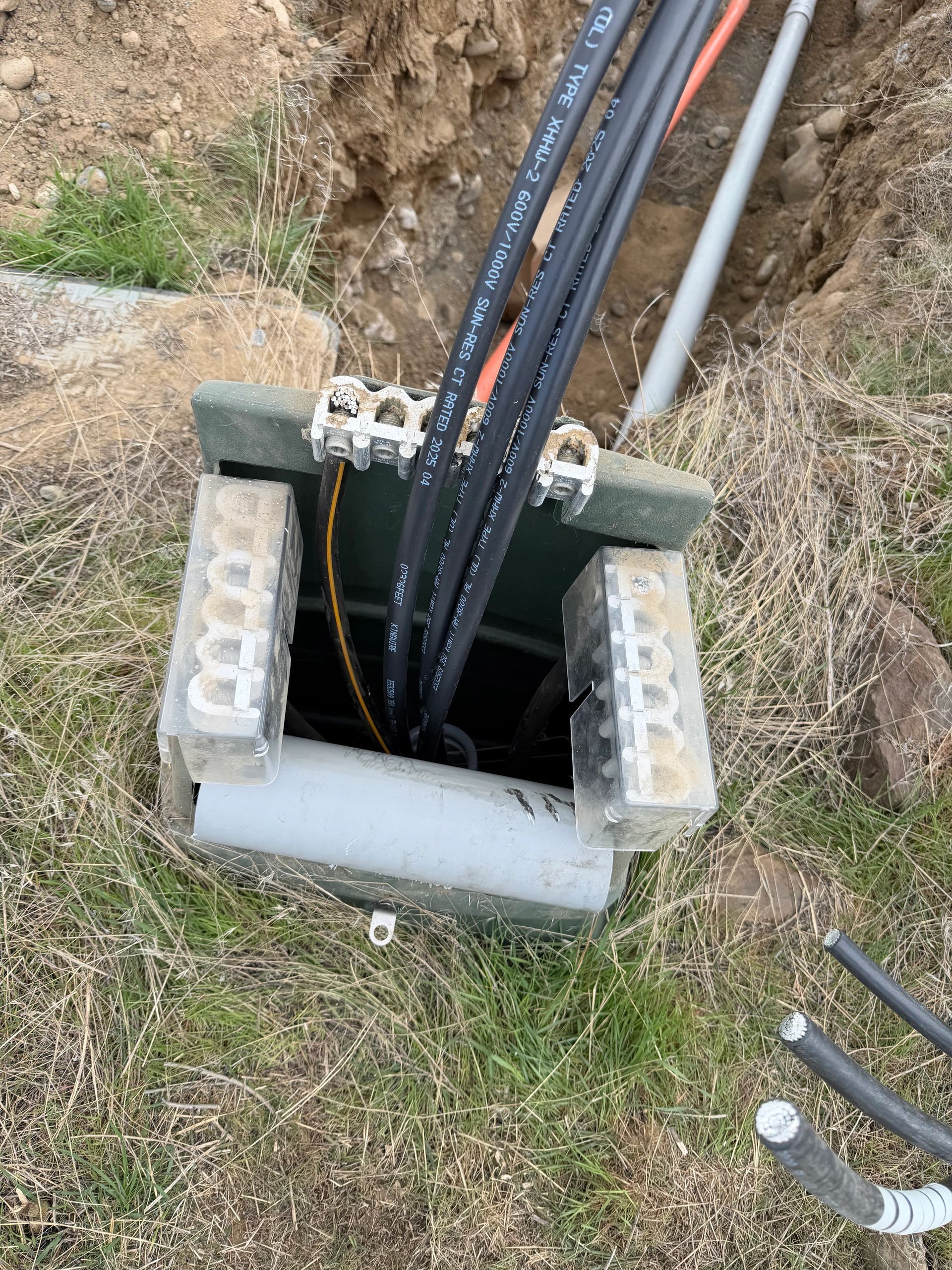 Underground commercial electrical service conductors entering a grade-level enclosure